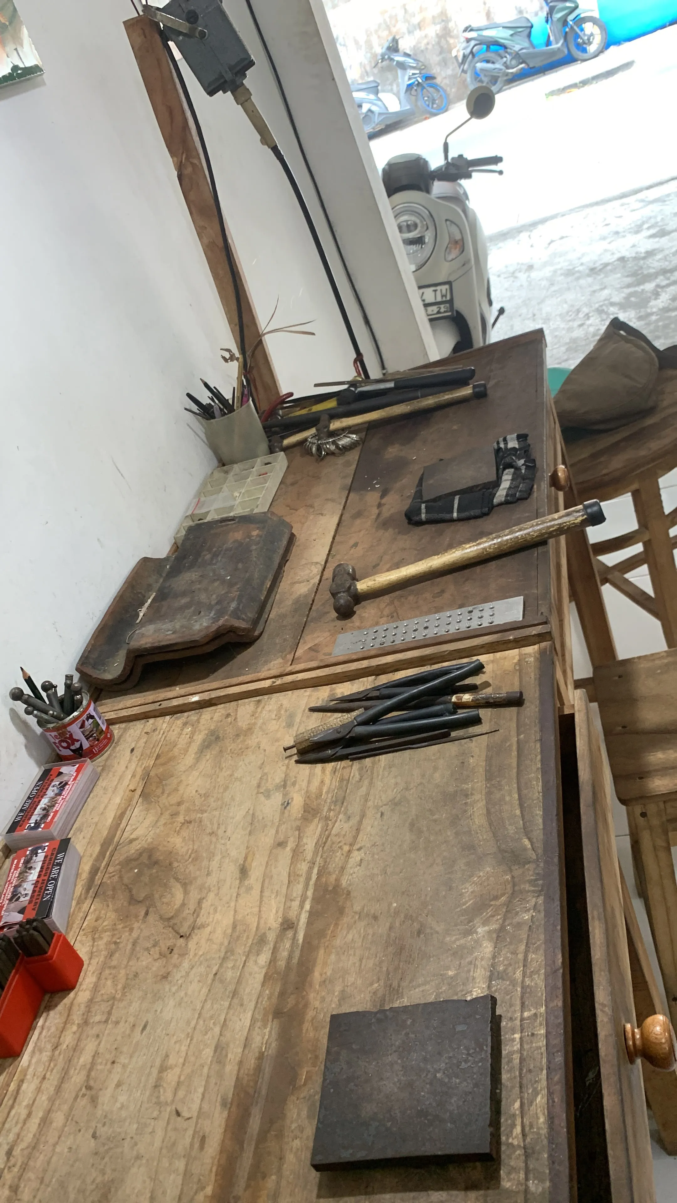 Wooden workbenches with jewellery-making tools — supplied reference photograph
